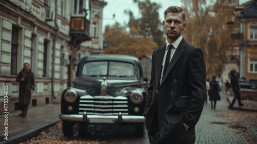 man in a suit against the background of a retro car © Андрей Трубицын