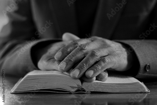praying to God with the bible on black background with people stock image stock photo