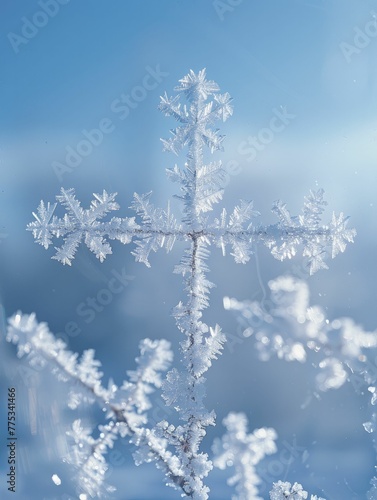Ice crystals forming a cross on a window, chilly blue background for frozen assets management.