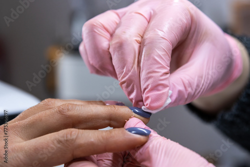 Detailed nail polish touch-up at professional beauty salon
