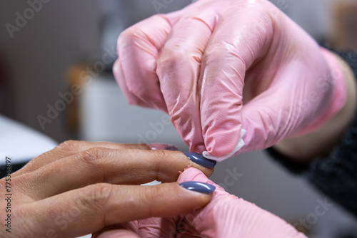 Fényképezés Detailed nail polish touch-up at professional beauty salon