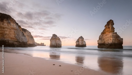 sea stacks on the beach at sunset algarve portugal