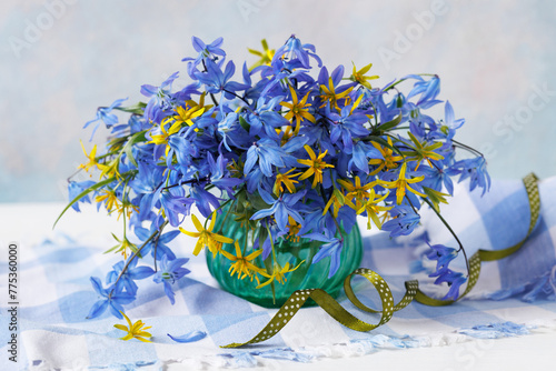 Bouquet in a vase of spring blue and yellow flowers, still life, beautiful postcard
