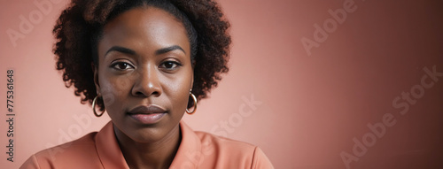 A 50S Adult African American Woman Isolated On A Coral Background With Copy Space