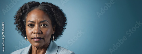A 50S Adult African American Woman Isolated On A Ice Blue Background With Copy Space