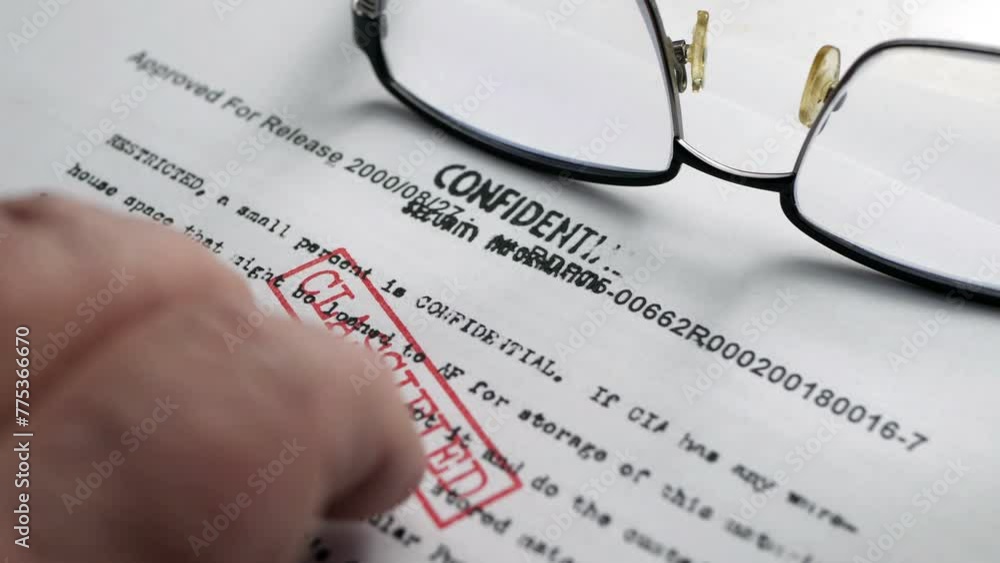 Finger tapping on top secret document Finger tapping on top secret document