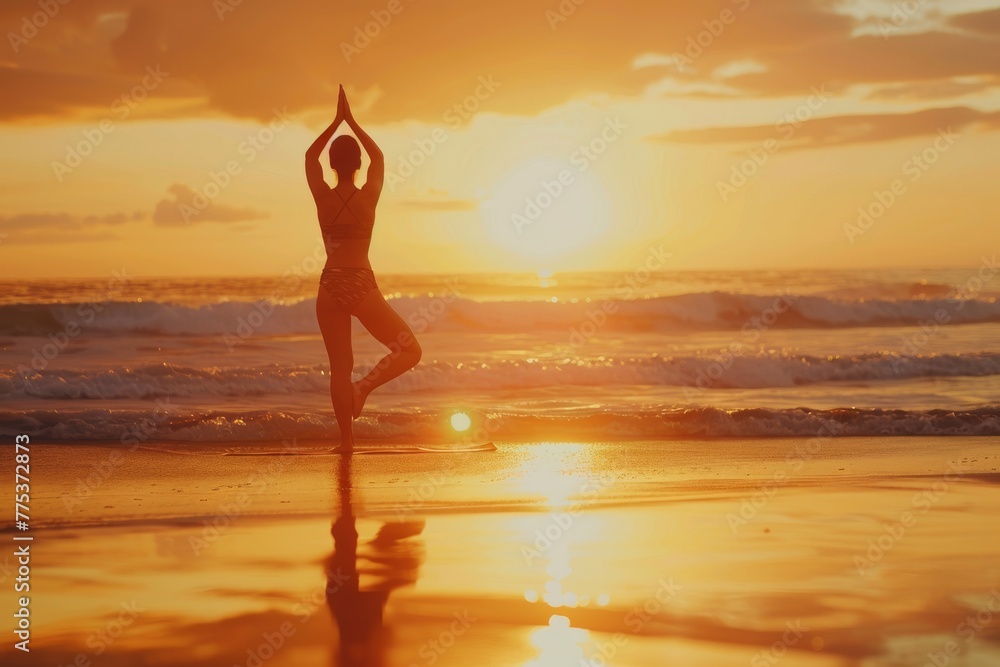Silhouetted person practicing yoga on the beach at sunset, embodying peace and tranquility