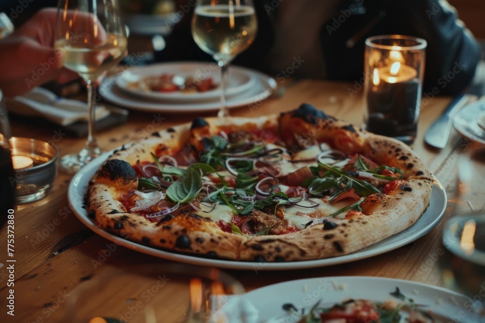Gourmet pizza served on a wooden table at an intimate dinner gathering
