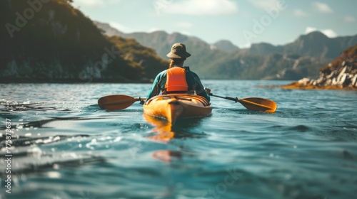 Adventurous person kayaking in the ocean, exploring scenic natural landscape © Fat Bee