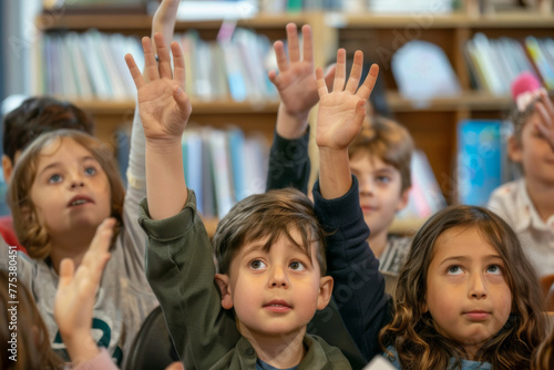 Group of preschool children raising hands in a colorful classroom.