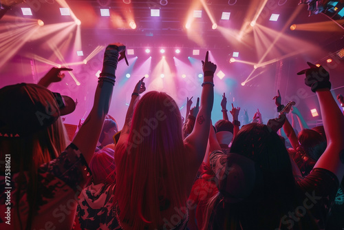 Energetic Crowd Raising Hands at Concert