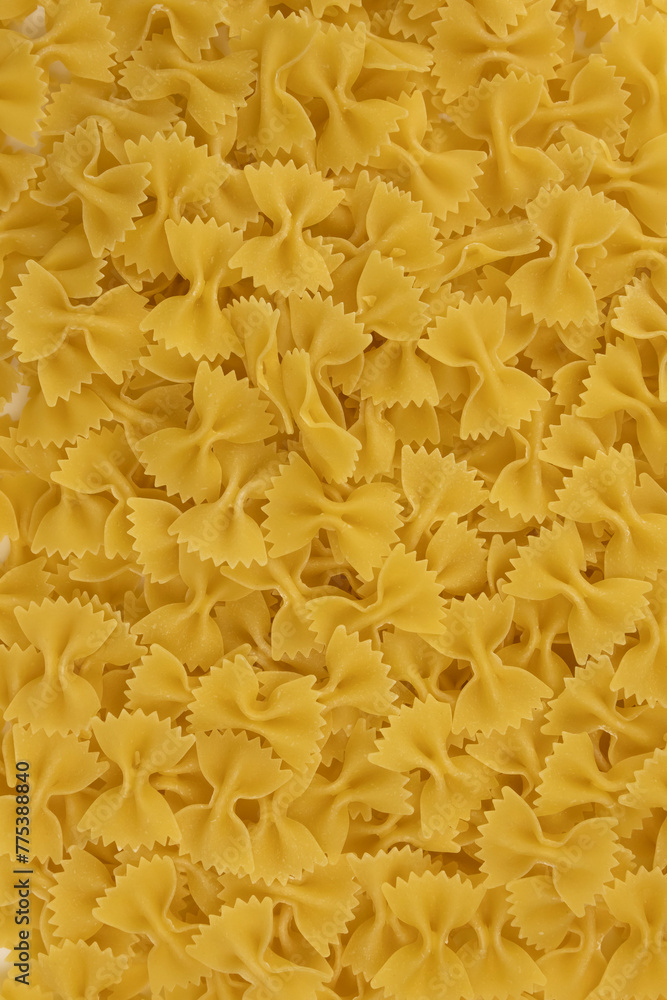 Obraz premium Background of raw Italian farfalle pasta close-up. Concept of pasta production.