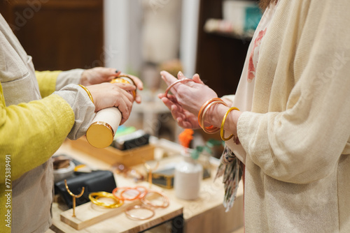 Women trying on bangles at a fashion store photo