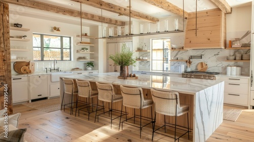A bright and airy farmhouse kitchen with white marble backsplash  oak cabinets  natural wood beams in the ceiling  an island bar in the center of it all and soft lighting.