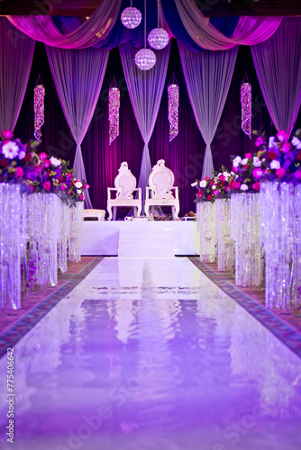 Wedding ceremony stage with white and purple decor