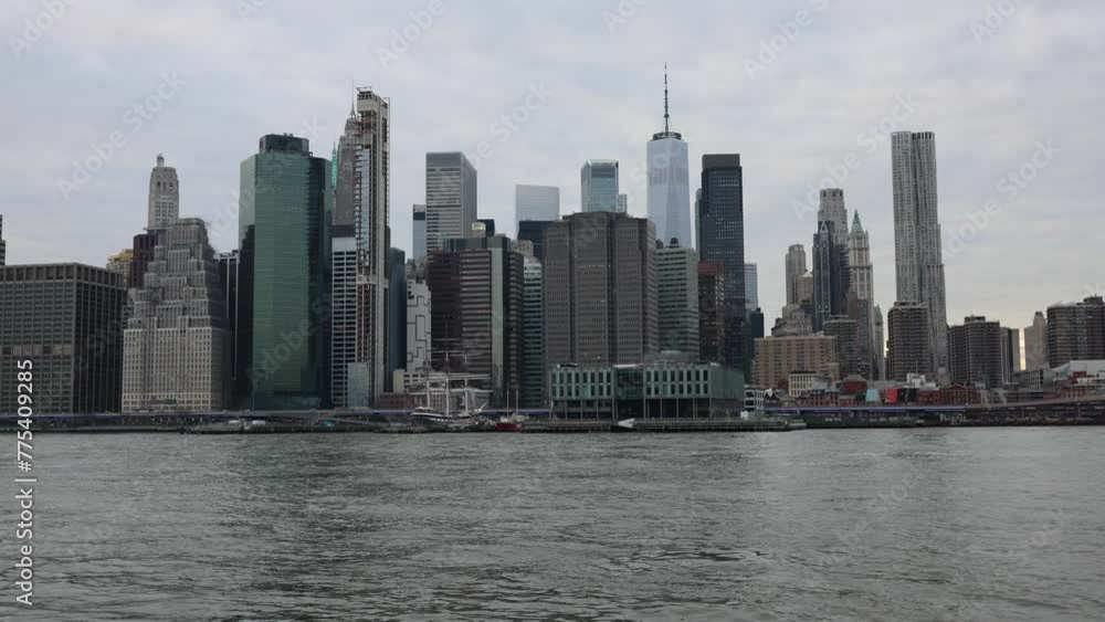 water flowing in the east river on the nyc waterfront with downtown new york city skyline in the background ( center, skyscraper) overcast sunset lower manhattan financial district water flowing in the east river on the nyc waterfront with downtown new york city skyline in the background ( center, skyscraper) overcast sunset lower manhattan financial district