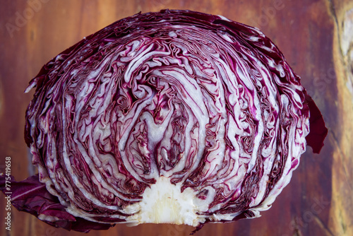 Cross section of a head of Radicchio on a wood background, food, vegetable, isolated