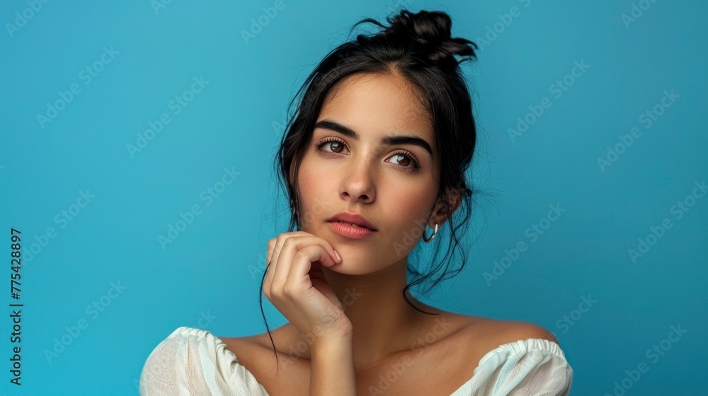 portrait of a beautiful latin girl on blue background