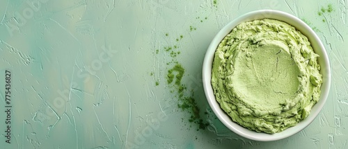  Green countertop with a bowl of guacamole resting near a knife and fork