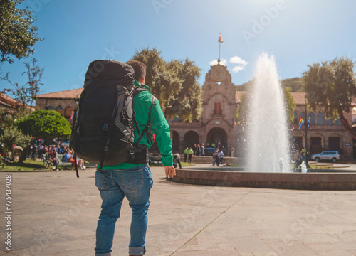 Tourist backpaker looking at square en Cuzco. Peru photo