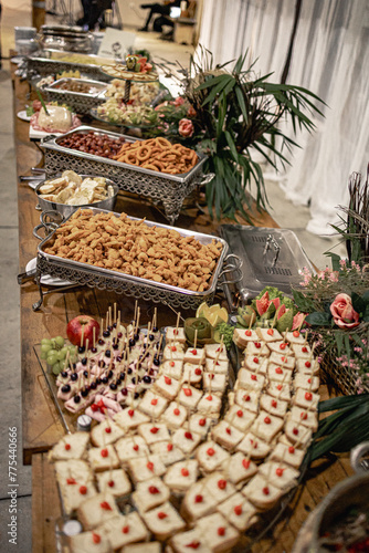 wooden table with stainless steel Richo with various types of food
