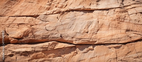 A lone figure balancing atop a rugged rock formation overlooking the landscape