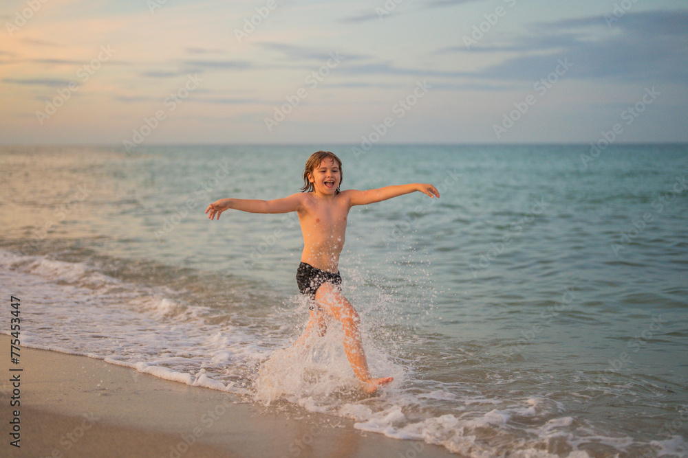 Kid running and splashing in the sea. Active little kid running along sea beach. Kid sport activity. Sporty kid running in nature. Happy childhood. Summer vacation. Child Running Along the beach. Kid running and splashing in the sea. Active little kid running along sea beach. Kid sport activity. Sporty kid running in nature. Happy childhood. Summer vacation. Child Running Along the beach.