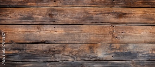 Weathered wooden wall with numerous aged planks closely stacked together  creating a rustic and textured surface
