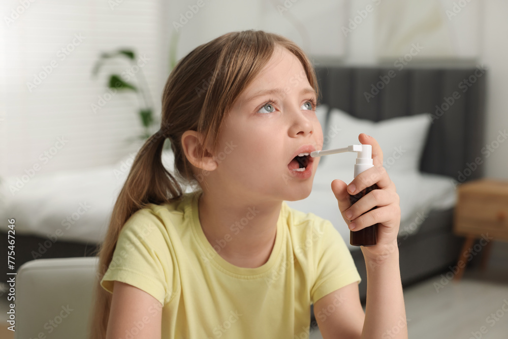 Little girl using throat spray at home Little girl using throat spray at home