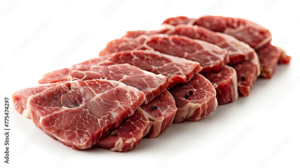 Raw sliced port meat being prepared on a plain white background. Raw sliced port meat being prepared on a plain white background.