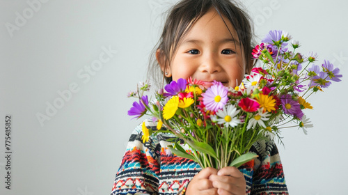 Happy, smiling kid with bunch of colorful flowers for mothers day or birthday celebration. White background, Isolated.  Horizontal banner. photo