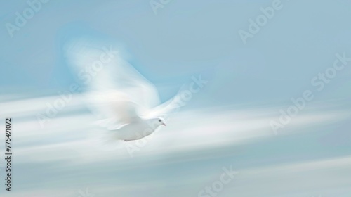 A white bird is flying through a clear blue sky