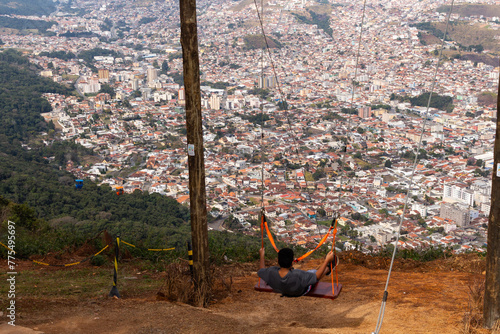 Balanço e Teleférico no Parque do Cristo - POÇOS DE CALDAS, MG, BRAZIL - JULY 19, 2023: Swing and cable car in Parque do Cristo (Christ Park) in the São Domingos mountains, with a view of the city.