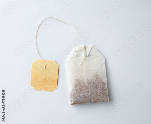 Top view of Teabag with yellow label isolated on white background