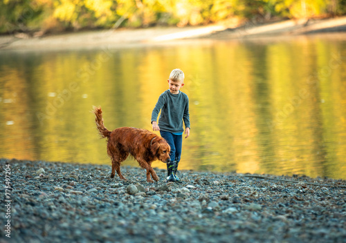 A boy person and his dog walking together at sunset  © kieferpix