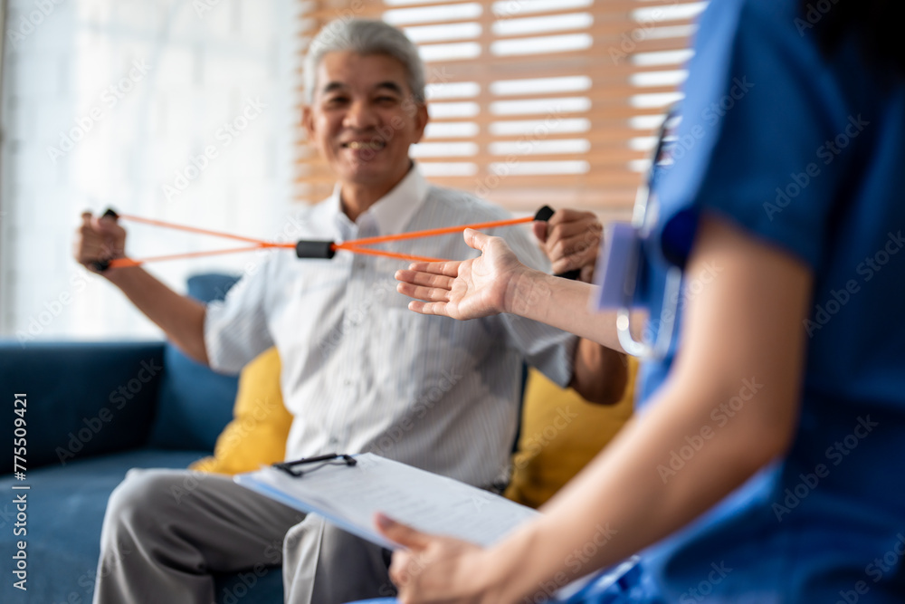 Obraz premium Asian senior elderly man doing physiotherapist with support from nurse. 