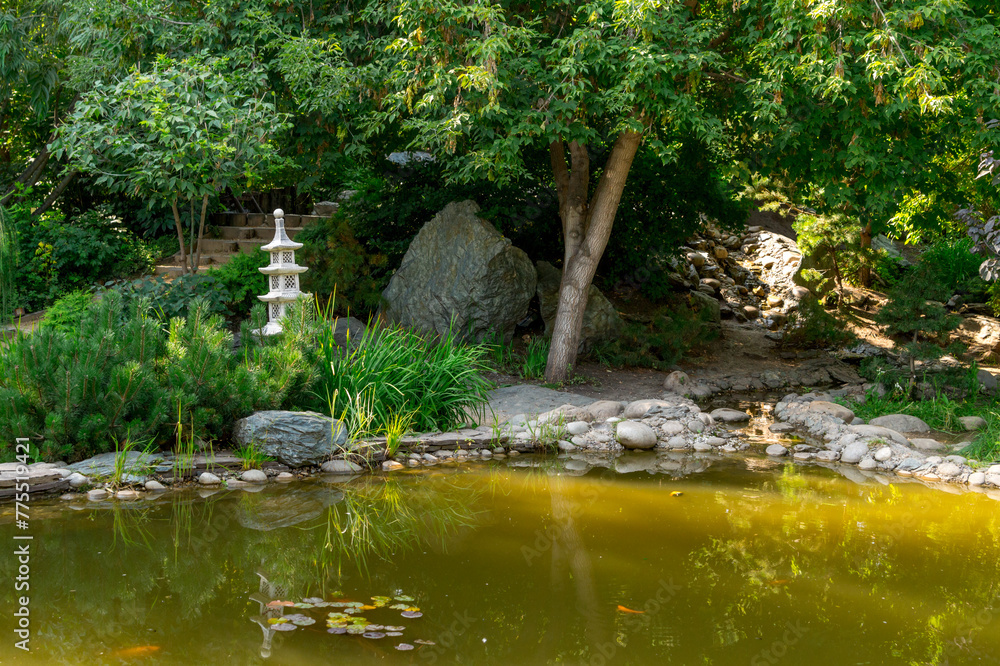 Japanese garden. A pond with a decorative pagoda on the shore.