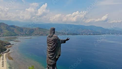 Cape Fatucama, Dili, East Timor - Rear View of Cristo Rei of Dili (Christ the King of Dili) Statue - Aerial Pullback Shot photo