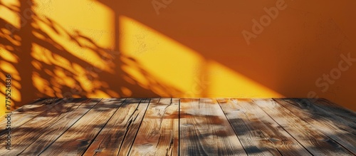 Close up of wooden floor against yellow wall