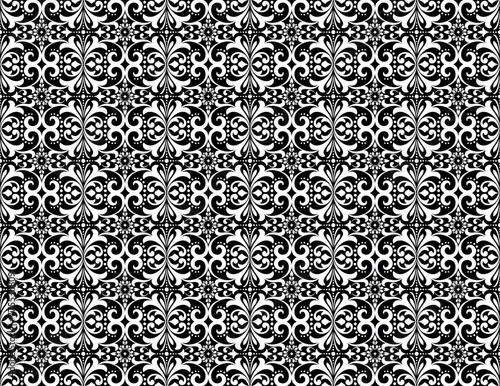 Wallpaper in the style of Baroque. Seamless vector background. White and black floral ornament. Graphic pattern for fabric, wallpaper, packaging. Ornate Damask flower ornament.