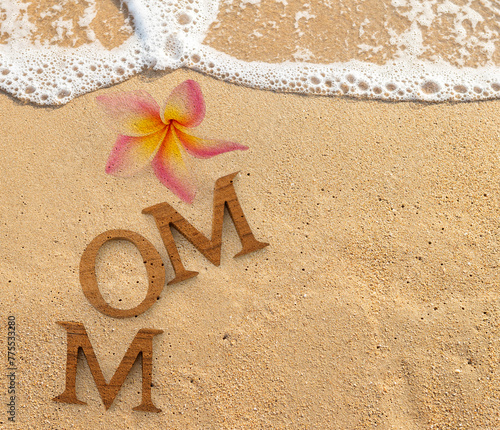 Mother's day card background idea, mom wooden font with flower with space on sandy beach