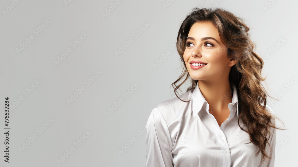 Indian business woman in white shirt smiling looking up towards copy space Indian business woman in white shirt smiling looking up towards copy space