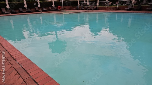 Abandoned Swimming Pool With Surrounding Chairs