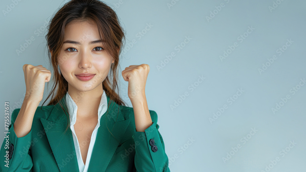 Asian Business Woman in green suit celebrate win, smile and raised hands Asian Business Woman in green suit celebrate win, smile and raised hands