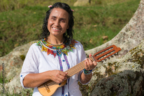 Cultural ambassadors perform traditional Colombian music amidst natural beauty. A  woman stands serenely, her traditional attire symbolizing wisdom and cultural heritage. 