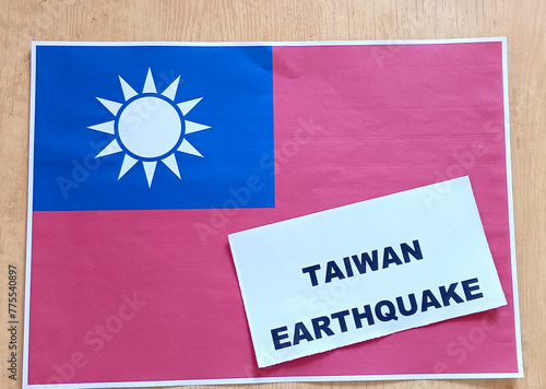 Closeup image of Taiwan earthquake and their flag printed in paper on desk. 