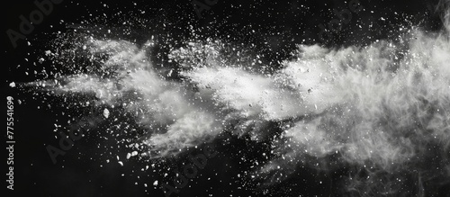 A person throwing powder in black and white