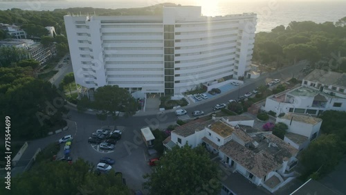 aerial orbit over on hotel buildings in front to the sea surrounded by rainforest, riviera maya, quintana roo, mexico. photo