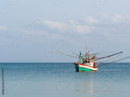 Fishing boat anchored against a clear sky. Sunny day. No people, outdoors. Concept of leisure and travel