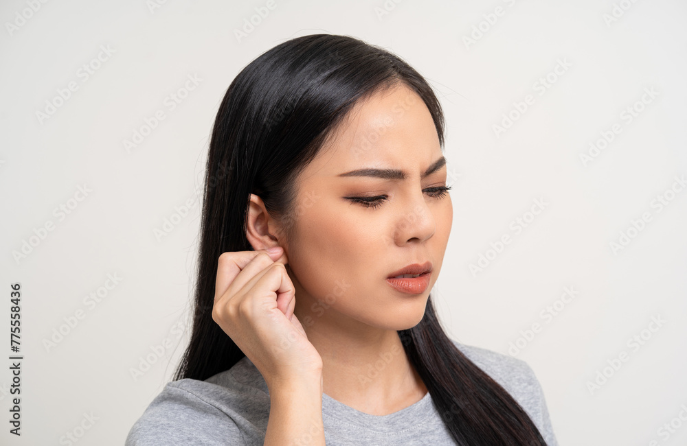 Young woman has a skin disease problems suffering from ear pain. She has an itch ears. She scratched her skin infection. Unwell unhealthy standing on isolated background Young woman has a skin disease problems suffering from ear pain. She has an itch ears. She scratched her skin infection. Unwell unhealthy standing on isolated background